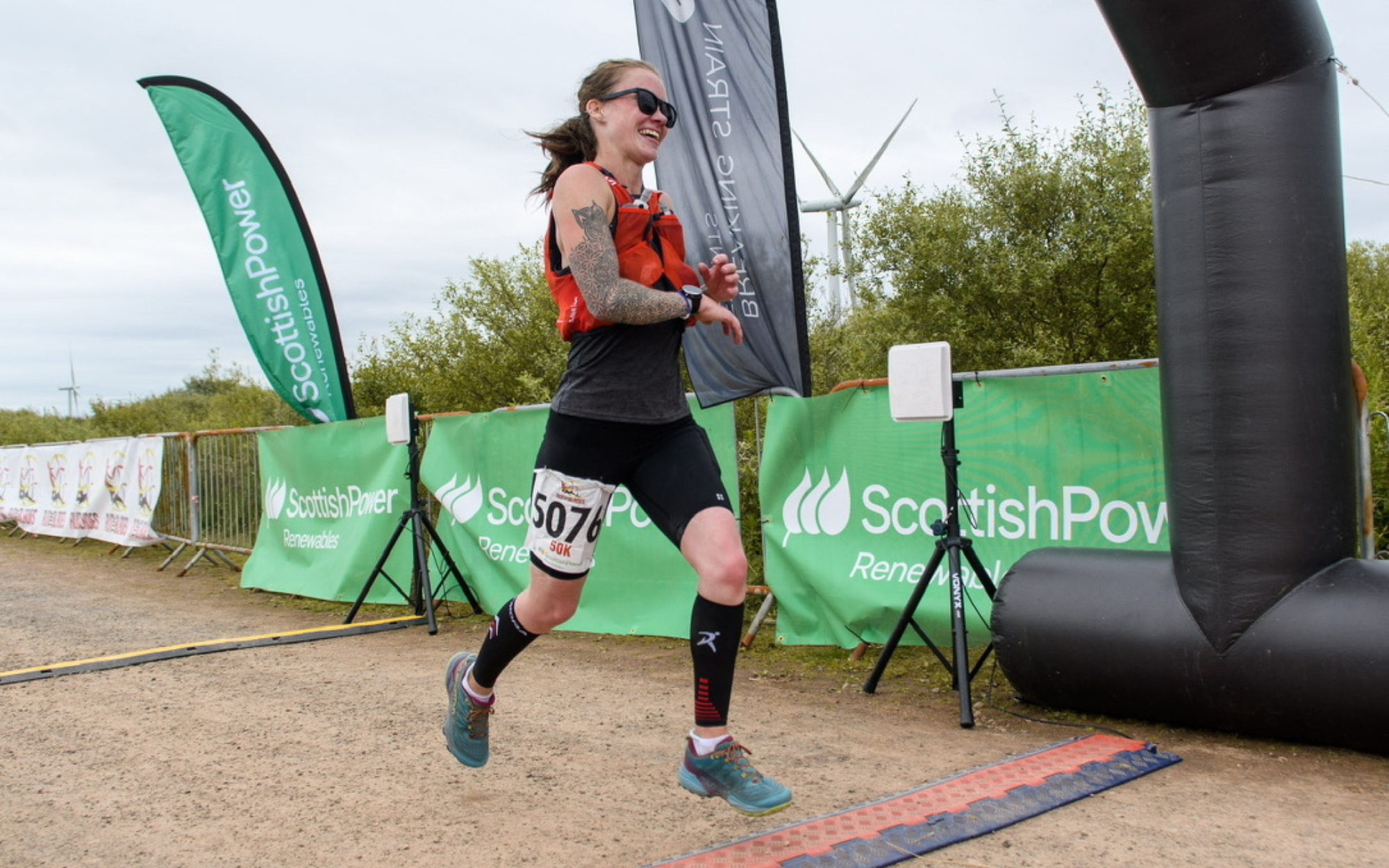 Sara Eydmann running up a mountain trail